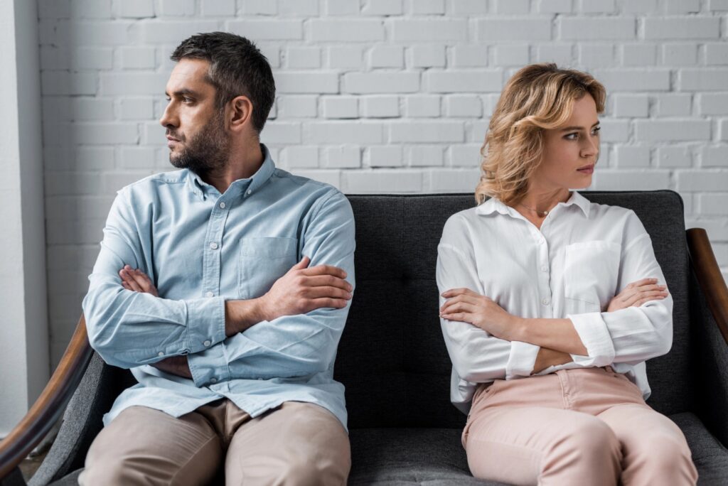 image1 Separated couple sitting apart while considering separation agreement and divorce options